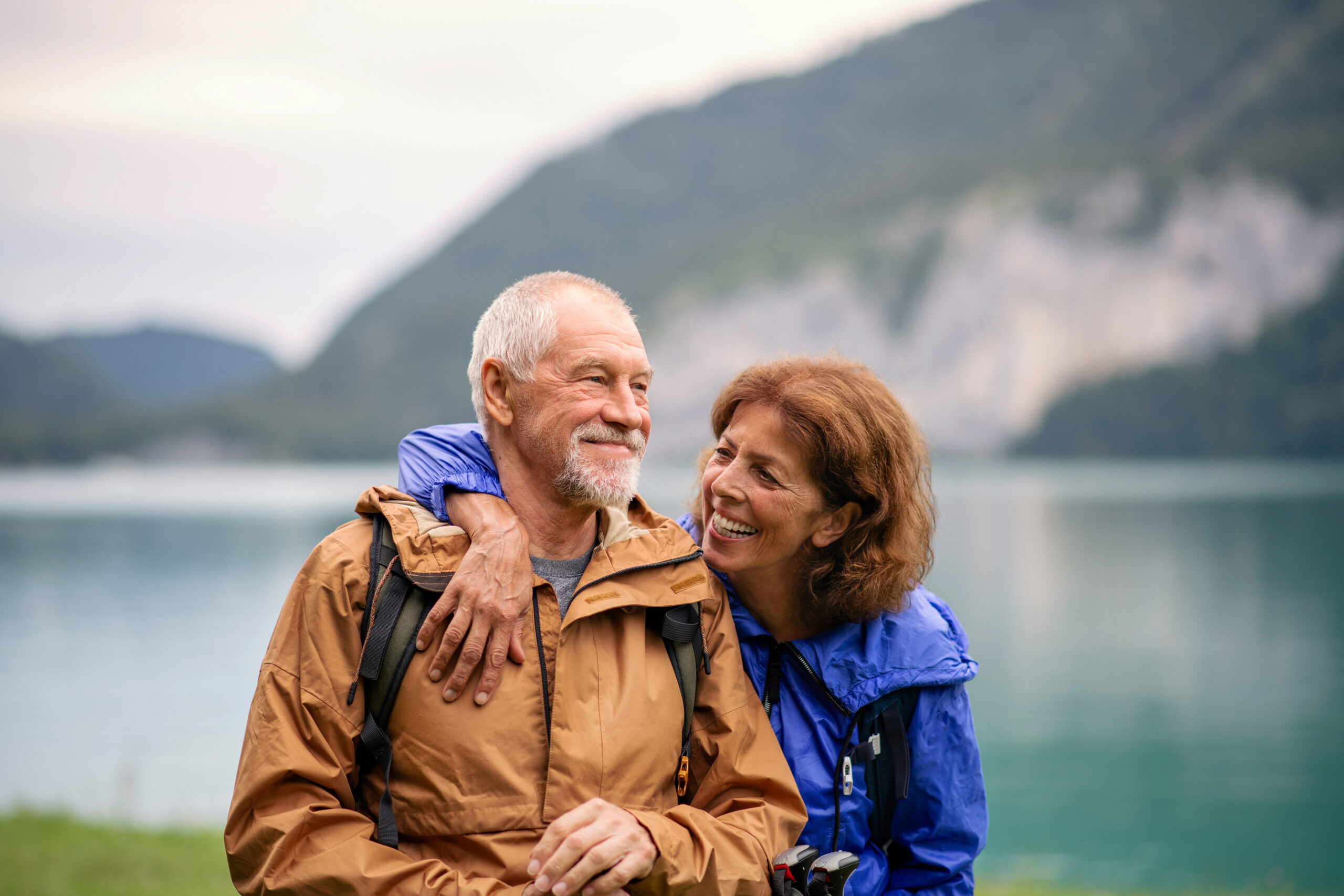 Happy senior couple enjoying nature by lake